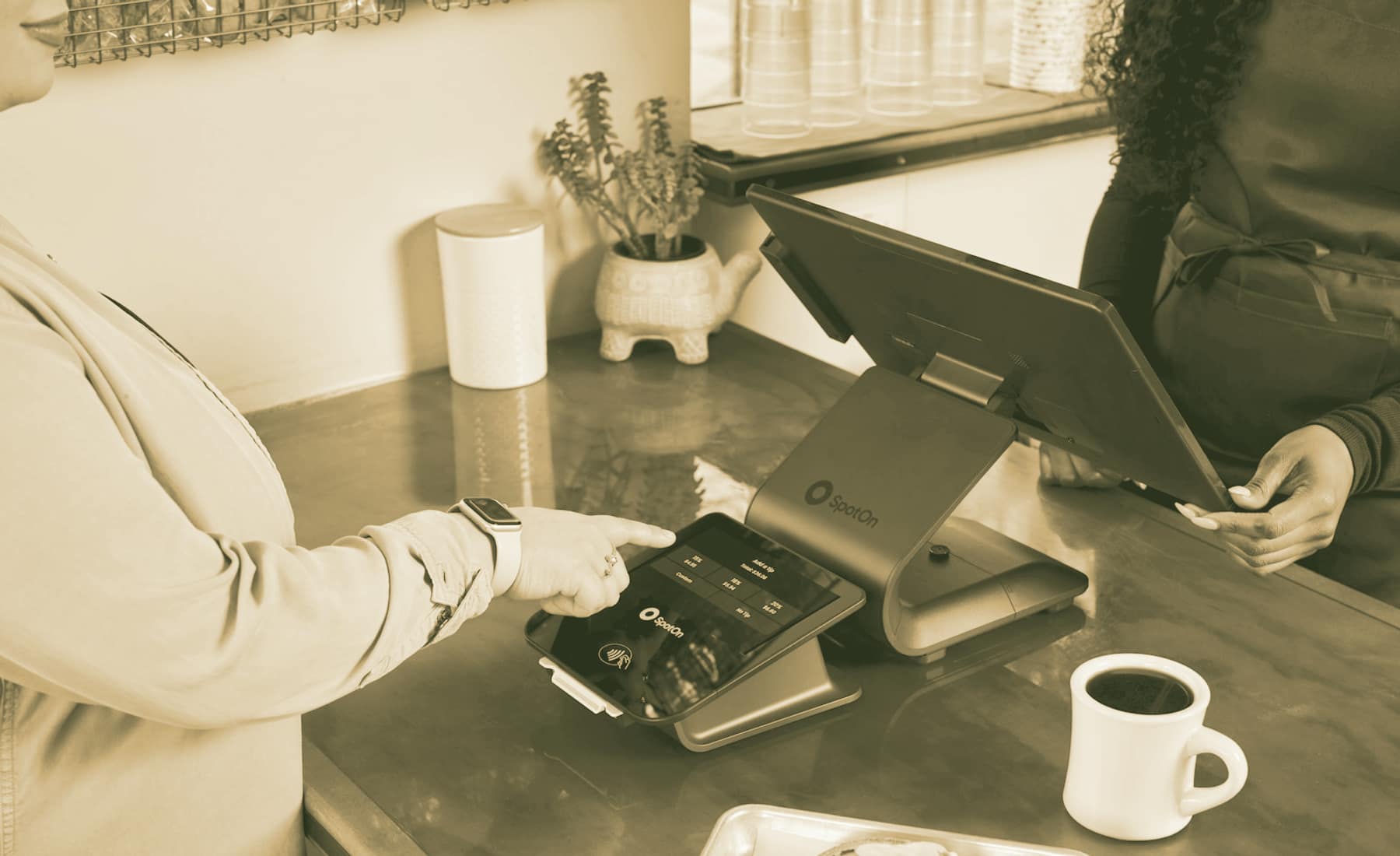 A card presented at a countertop payment terminal.
