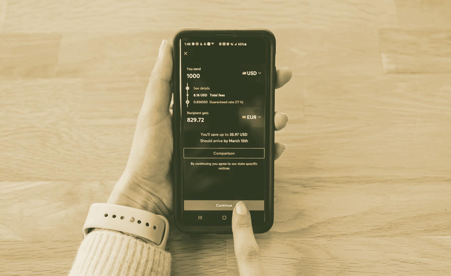 A phone showing a cross-currency transfer being set up.